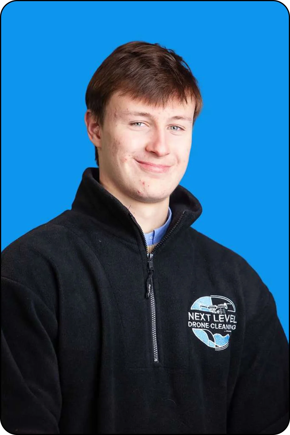 Sebastien in the branded quarter-zip